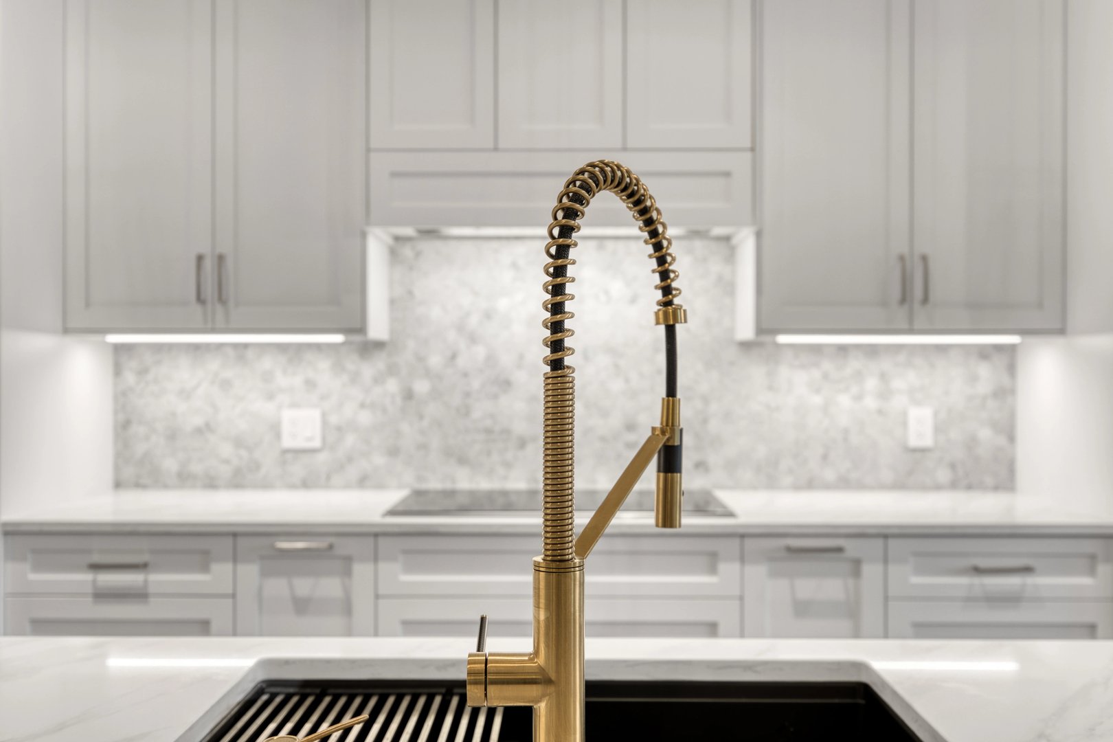 White kitchen with gold faucet